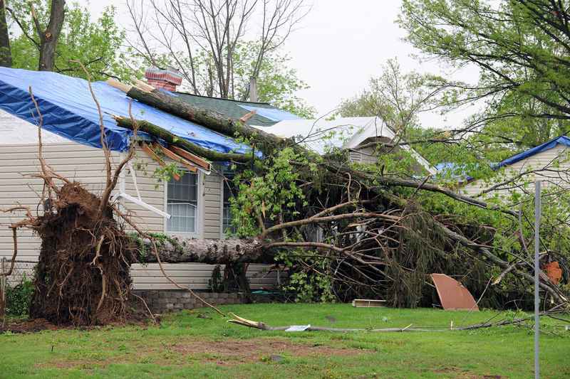 Missing shingles and visible damage on a residential roof after a severe storm in Des Moines, IA